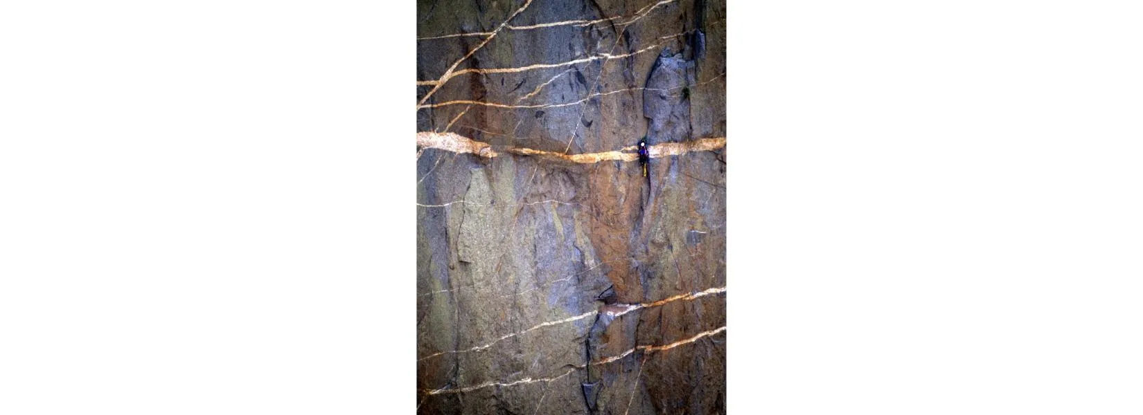 Rock climber ascending the dark walls of Black Canyon of the Gunnison